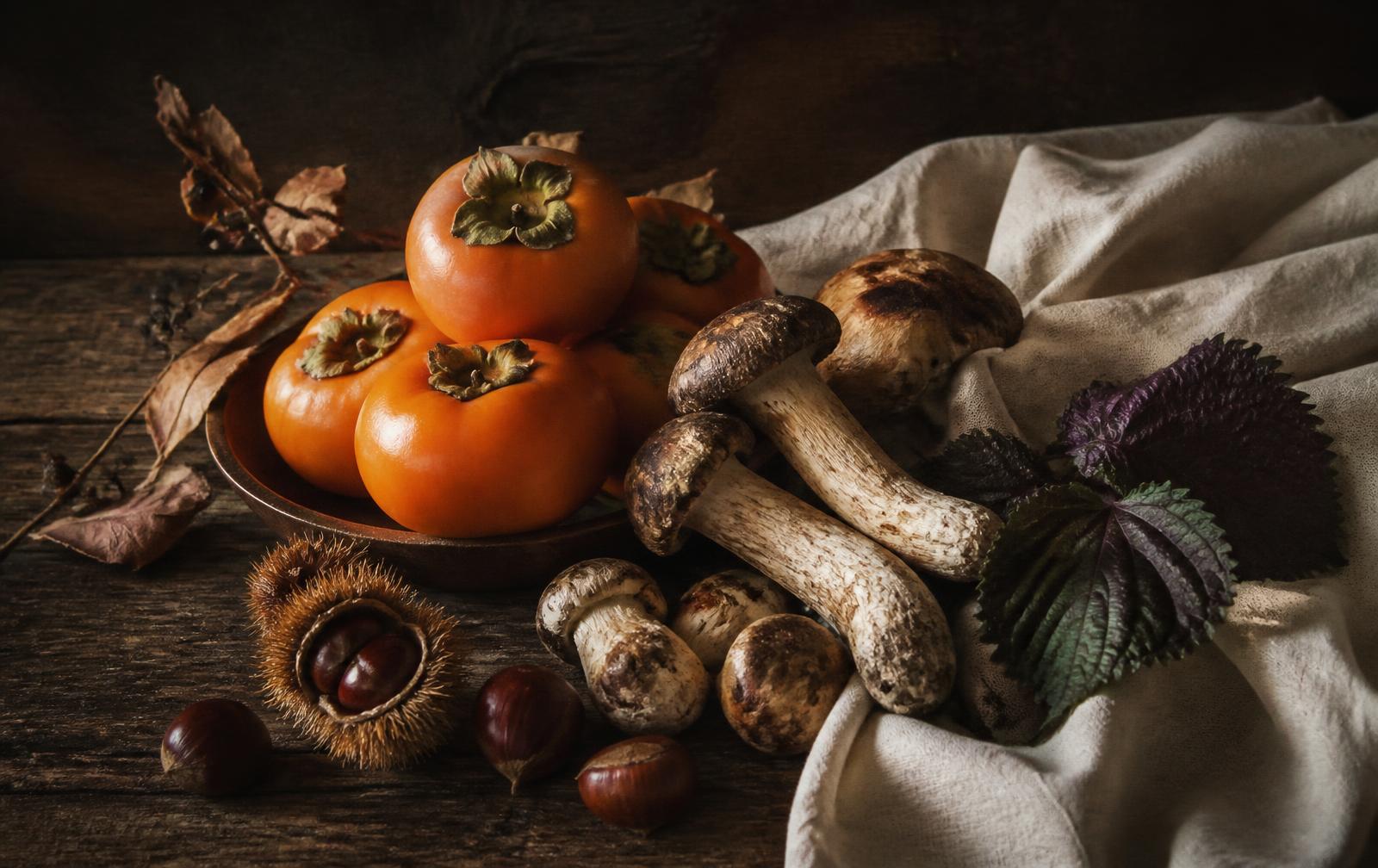 Autumn still life of persimmons, pine mushrooms and chestnuts